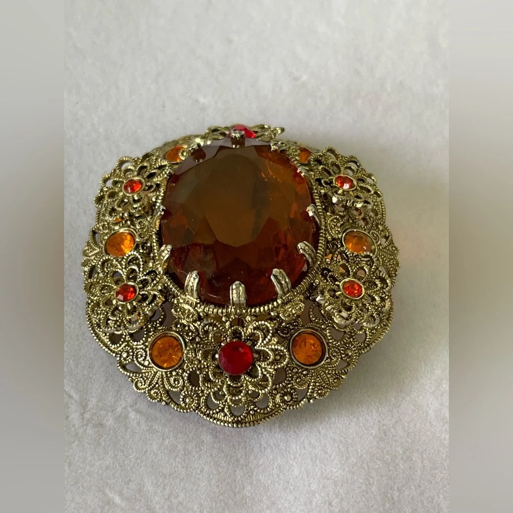 Vintage West Germany brooch featuring a large amber topaz glass filigree gold